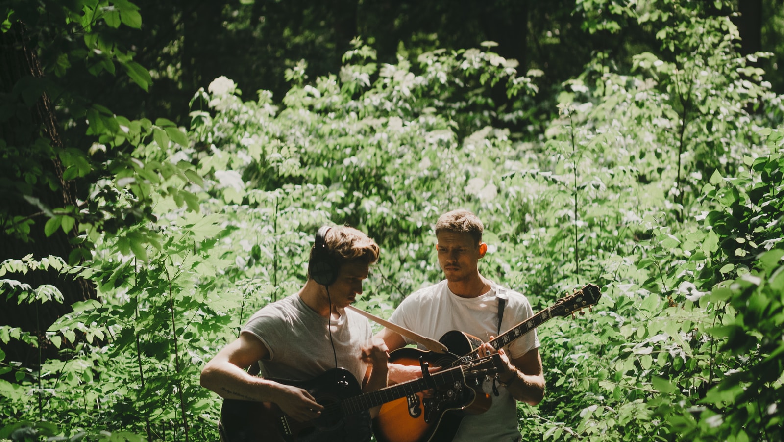 two men playing guitar